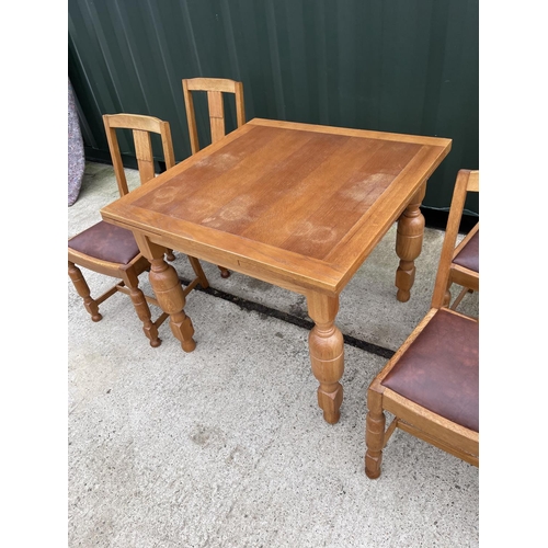 304 - An oak drawer leaf table and four chairs