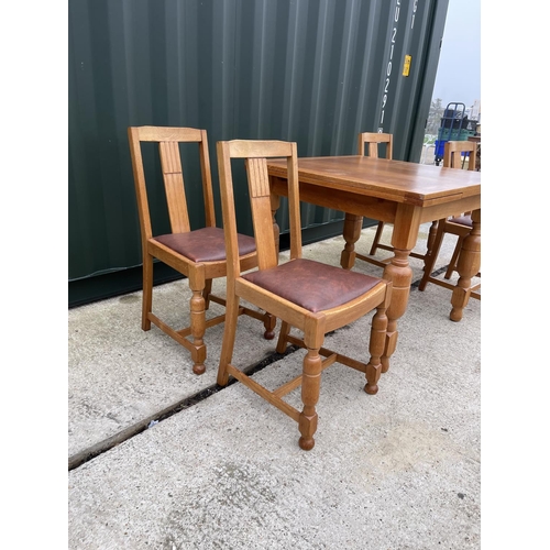 304 - An oak drawer leaf table and four chairs