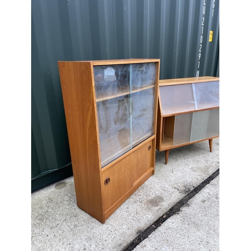 305 - Two mid century glazed cabinets with glass sliding doors