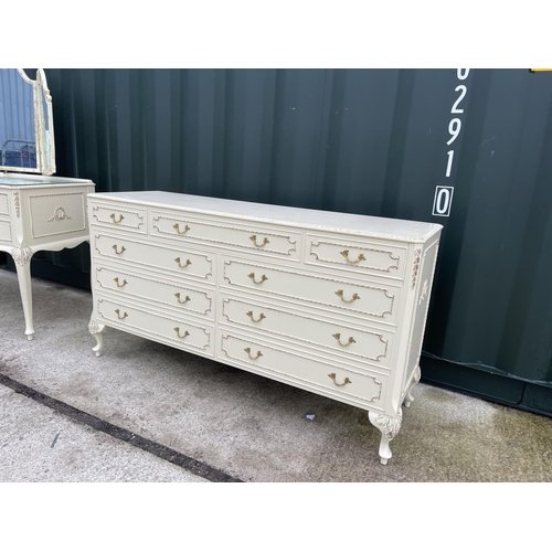 317 - A white painted and gold gilt french style bedroom pair consisting of a large 9 drawer chest of draw... 