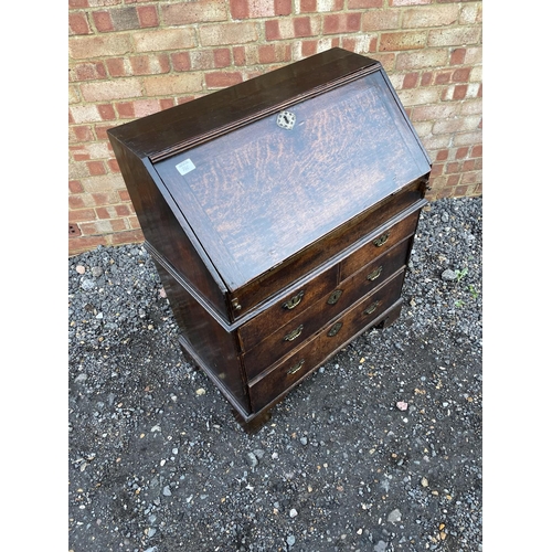 336 - A Georgian oak bureau, fitted to the interior with drawers, stationery rack and concealed well