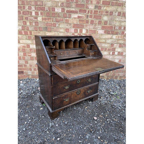 336 - A Georgian oak bureau, fitted to the interior with drawers, stationery rack and concealed well