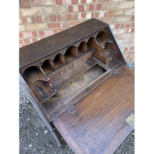 336 - A Georgian oak bureau, fitted to the interior with drawers, stationery rack and concealed well