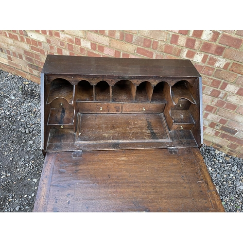 336 - A Georgian oak bureau, fitted to the interior with drawers, stationery rack and concealed well