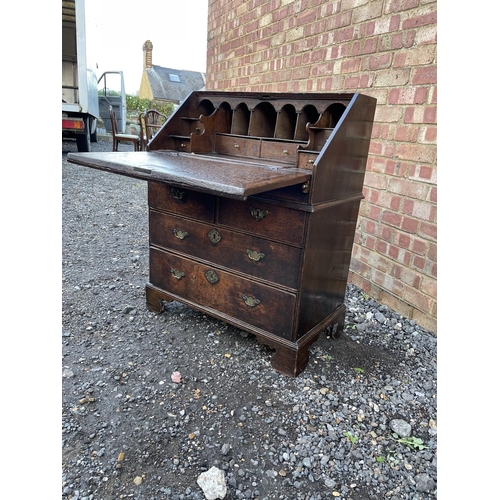 336 - A Georgian oak bureau, fitted to the interior with drawers, stationery rack and concealed well