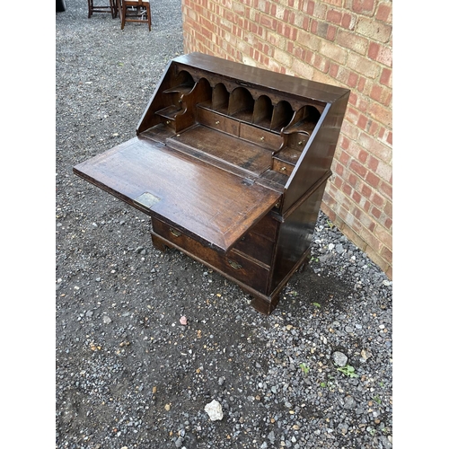 336 - A Georgian oak bureau, fitted to the interior with drawers, stationery rack and concealed well