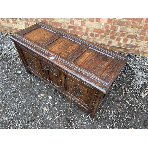 344 - An antique oak three panel carved  blanket box coffer