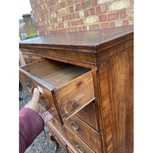 352 - A Georgian walnut chest of five drawers raised on two drawer stand