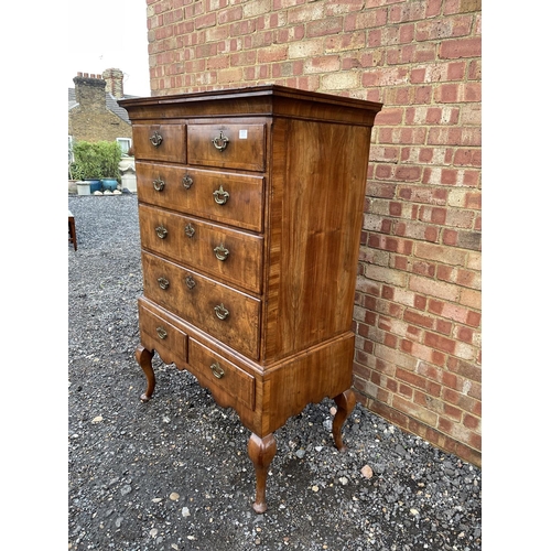 352 - A Georgian walnut chest of five drawers raised on two drawer stand