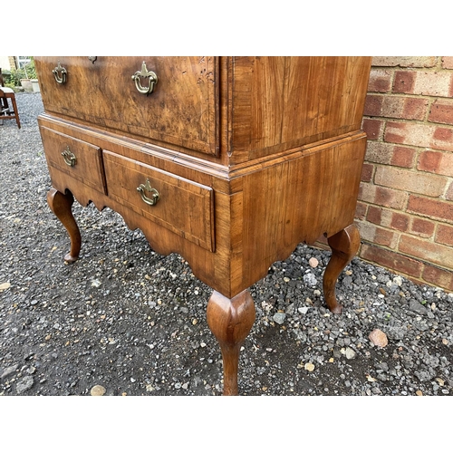 352 - A Georgian walnut chest of five drawers raised on two drawer stand