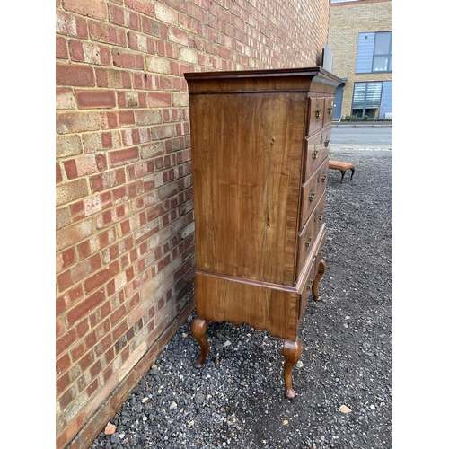 352 - A Georgian walnut chest of five drawers raised on two drawer stand