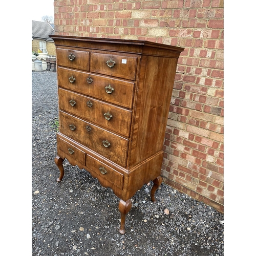 352 - A Georgian walnut chest of five drawers raised on two drawer stand