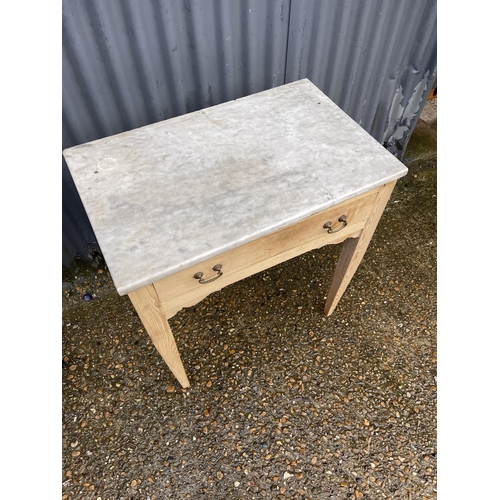 354 - A country pine single drawer table with a marble top