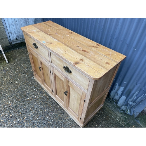 356 - A country pine sideboard with two drawers ver four cupboard doors