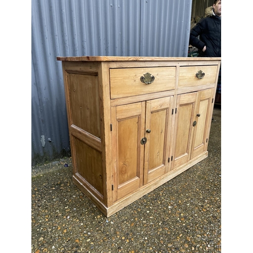 356 - A country pine sideboard with two drawers ver four cupboard doors