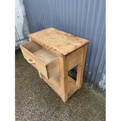 357 - An antique pine butcher block table with one drawer