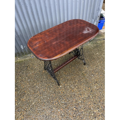 363 - A mahogany table on cast iron tressel base