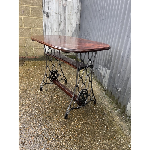 363 - A mahogany table on cast iron tressel base