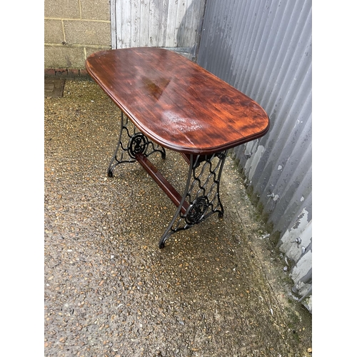 363 - A mahogany table on cast iron tressel base