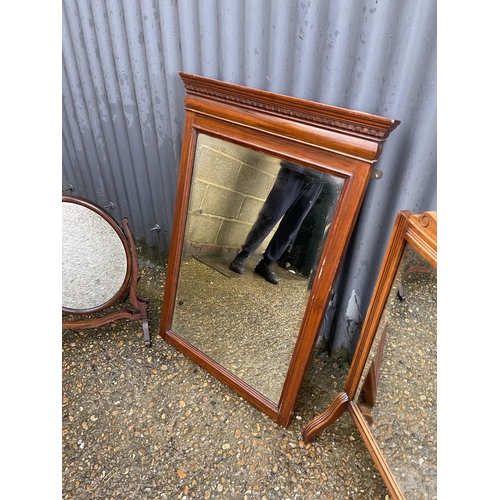 364 - An Edwardian mirror together with a mirrored fire guard and an oval swing mirror