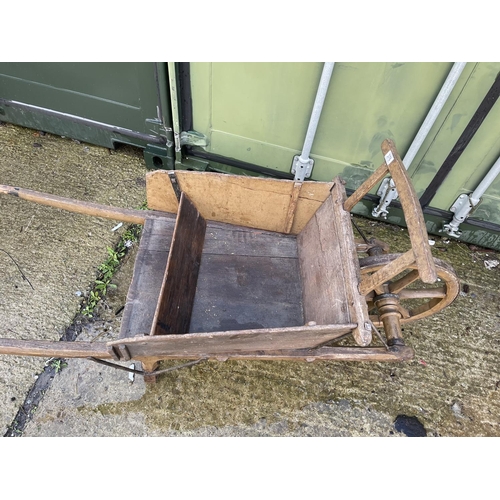 376 - A vintage wooden push barrow cart with removable sides