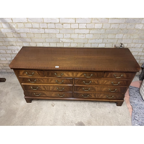 381 - A large reproduction mahogany lowboy chest of nine drawers