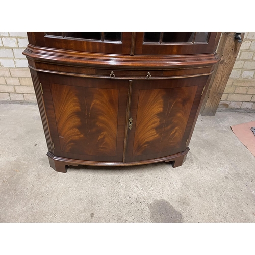 383 - A large reproduction mahogany double door corner cabinet