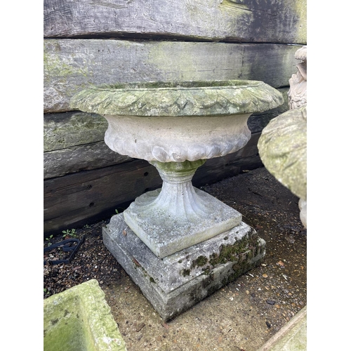 390 - A pair of large circular concrete pedestal urns, raised on square concre plinths 62 diameter. X 66hi... 