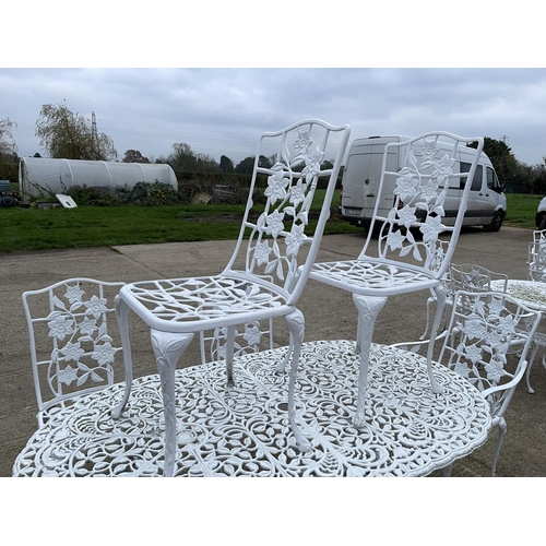 390a - A large white painted aluminium garden table together with 8 matching chairs