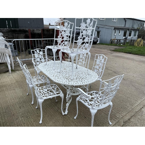 390a - A large white painted aluminium garden table together with 8 matching chairs