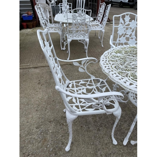 390b - A circular white painted aluminum garden table with four chairs