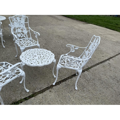 390c - A small white painted aluminum occasional table with three carver chairs