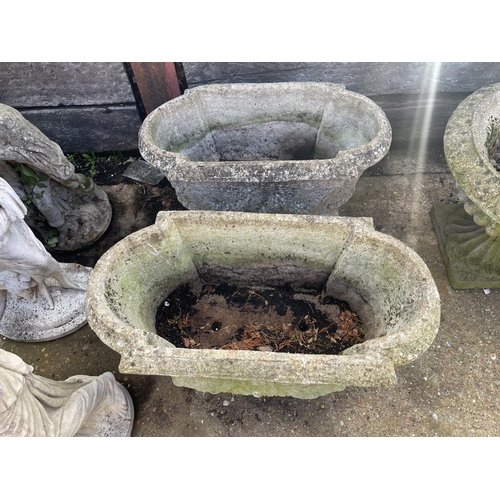 396 - A set of three oblong concrete planters 80x40x30 raised on feet