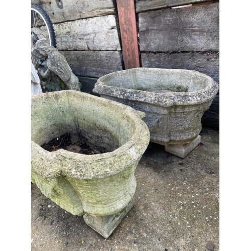 396 - A set of three oblong concrete planters 80x40x30 raised on feet