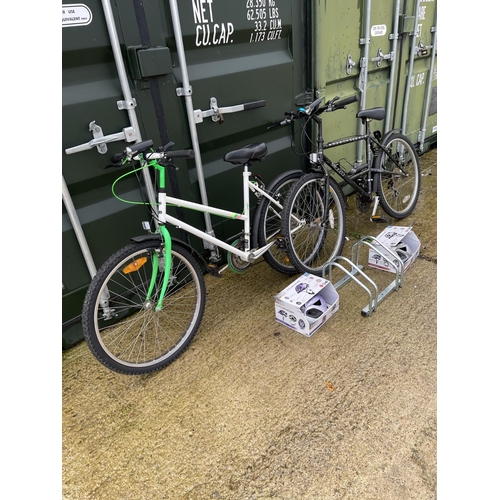 400e - A ladies and gents mountain bikes together with standard two  new helmets