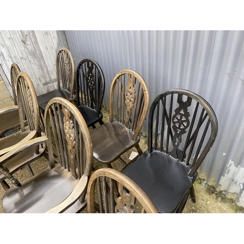 45 - 8 wheel back dining chairs including two carvers