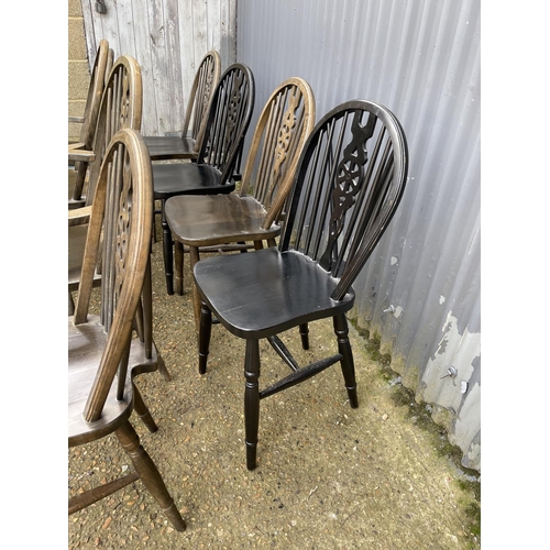 45 - 8 wheel back dining chairs including two carvers