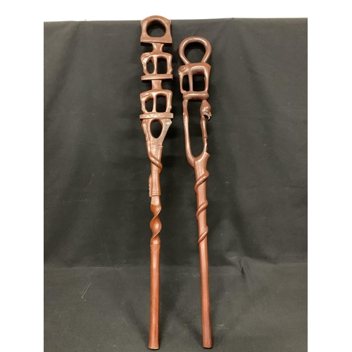 502 - 2 Ethnic carved sticks, longest 99cms