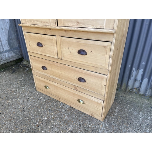 50k - A country pine linen press / larder cupboard with two door top over four drawers  (with key)