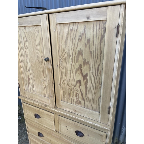 50k - A country pine linen press / larder cupboard with two door top over four drawers  (with key)