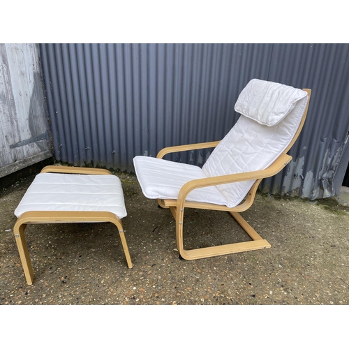 56 - A modern cantilever lounger chair with matching footstool