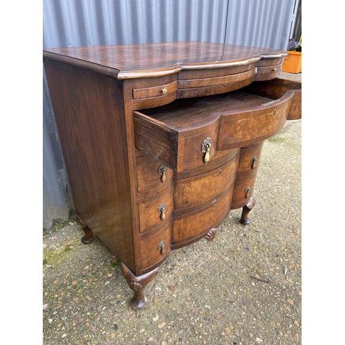 60 - A Queen Anne style walnut bachelors chest of four drawers with brushing slide