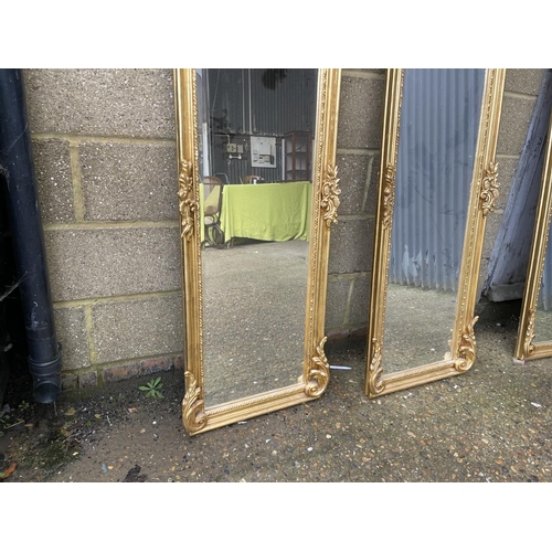 67 - A pair of large gold gilt hallway mirrors with lady decorative panels 180x54