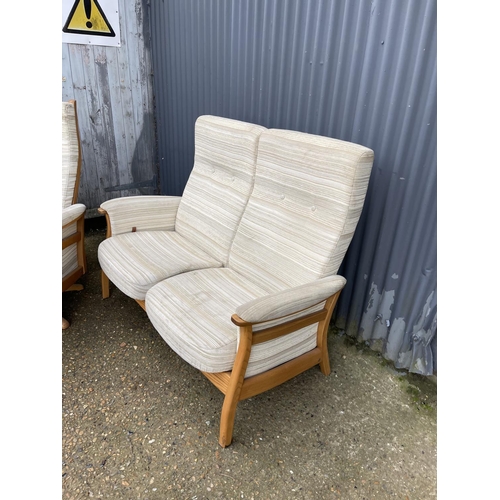 69 - A MODERN ERCOL upholstered two seater recliner sofa together with matching revolving armchair with s... 