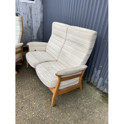 69 - A MODERN ERCOL upholstered two seater recliner sofa together with matching revolving armchair with s... 