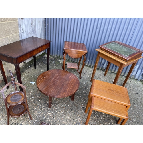 74 - Three mahogany occasional tables, oak table, cake stand, writing slope, nest of two and an oak mirro... 