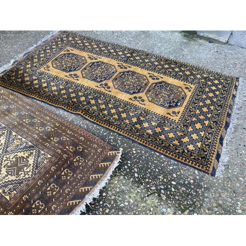 75 - Two gold pattern oriental rugs (larger 200x107)