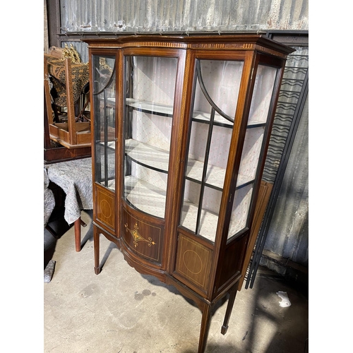 79 - An Edwardian inlaid cabinet with bow glass front