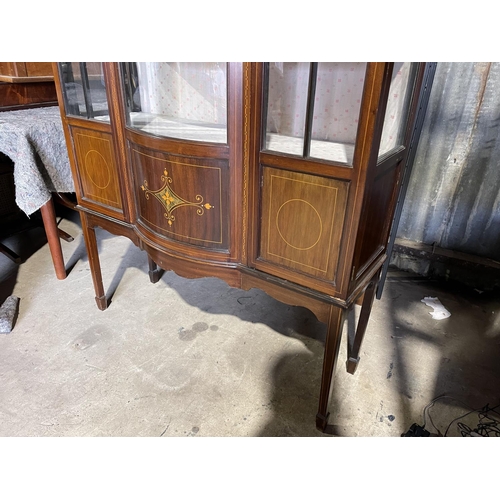 79 - An Edwardian inlaid cabinet with bow glass front