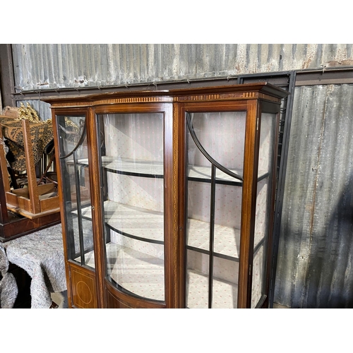 79 - An Edwardian inlaid cabinet with bow glass front